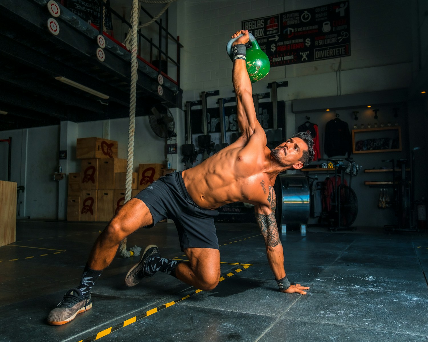 Anavar vs Clenbuterol man in black shorts and black tank top doing push up