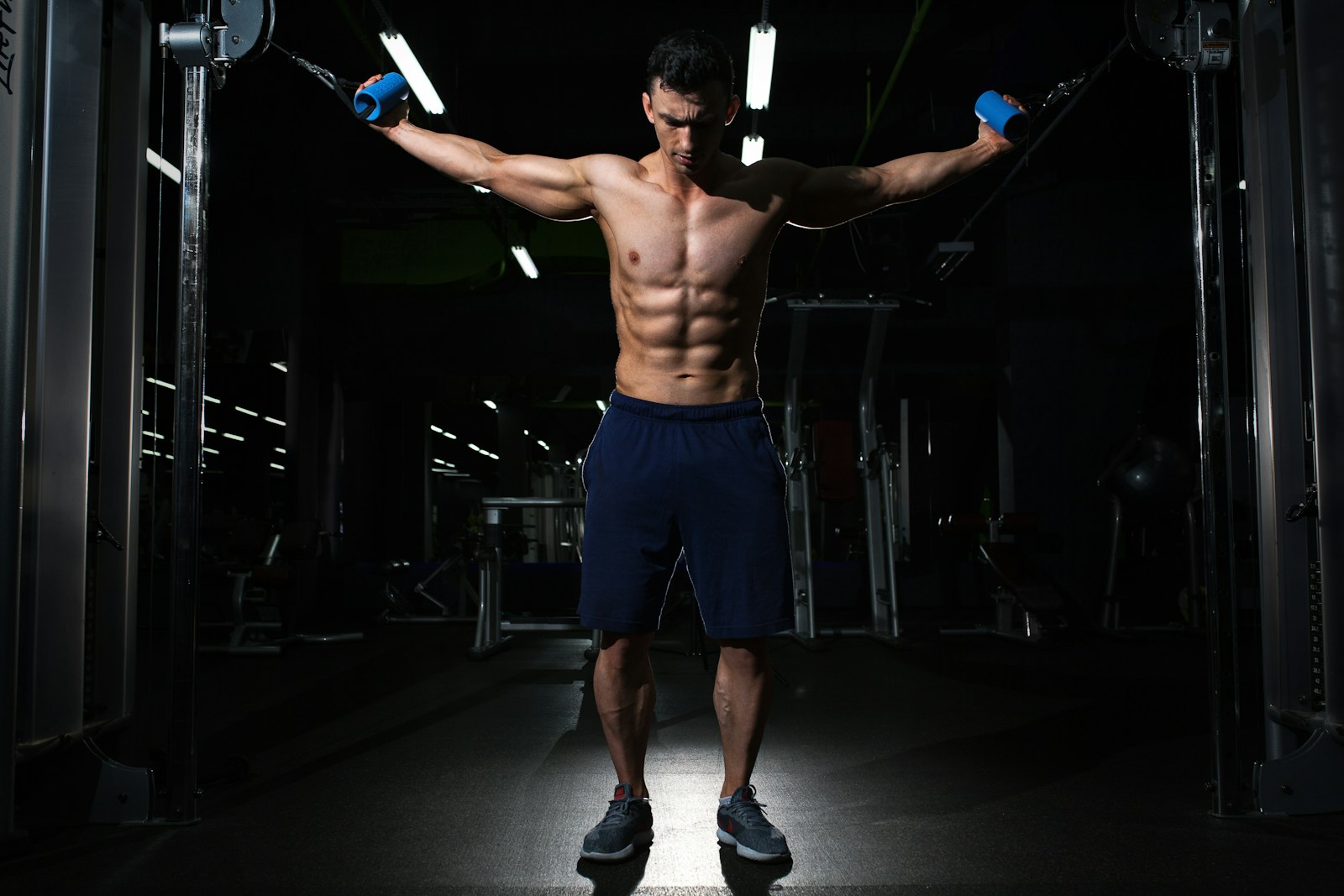Anavar vs Anadrol man exercising inside dim room