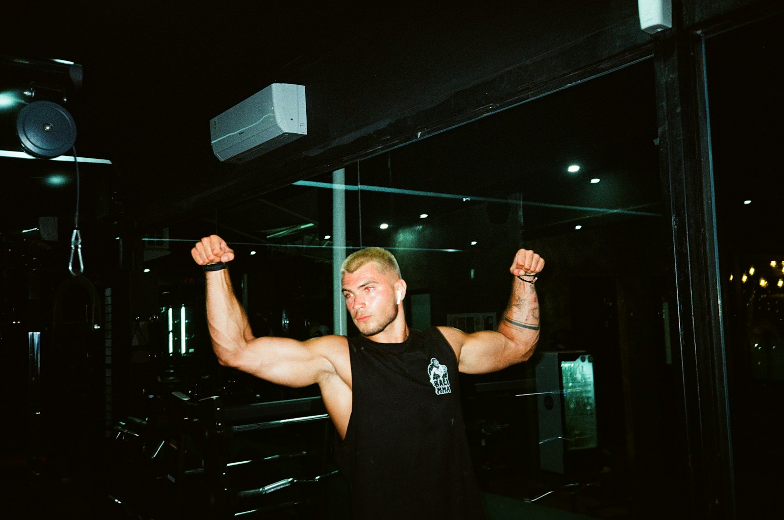 a man flexing his muscles in a gym